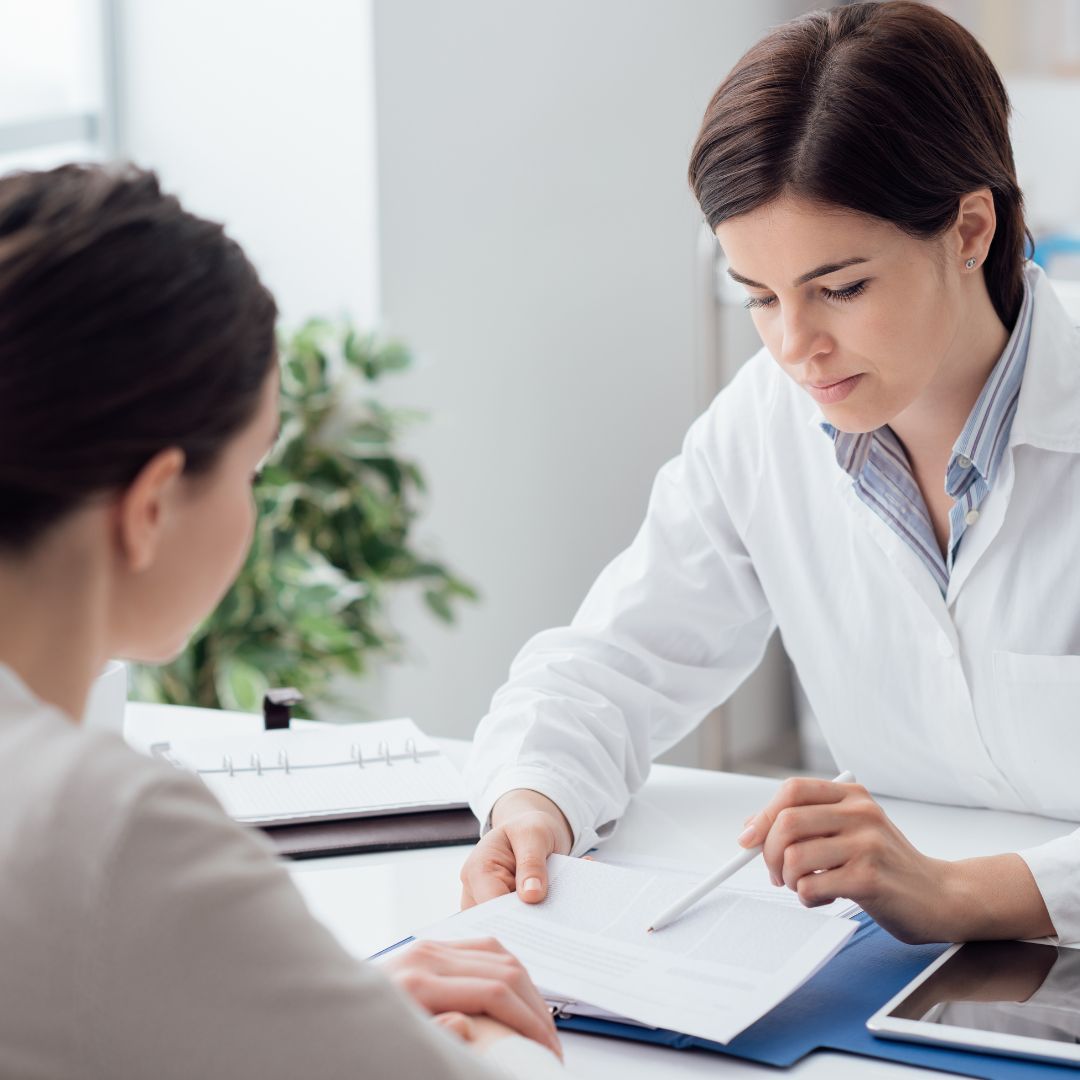 Woman discussing PCOS PMOS symptoms and diagnosis with her GP